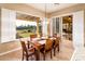 Bright dining area with shutters and sliding doors leading to covered patio with view of the golf course at 22020 N San Ramon Dr, Sun City West, AZ 85375