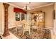 Elegant dining room featuring a glass table, decorative column, and custom china cabinet at 22020 N San Ramon Dr, Sun City West, AZ 85375