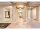 Open-concept foyer with travertine floors leading to the living spaces at 22020 N San Ramon Dr, Sun City West, AZ 85375