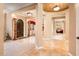 Welcoming foyer with travertine flooring and decorative columns at 22020 N San Ramon Dr, Sun City West, AZ 85375