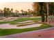 Scenic golf course view with sand traps and vibrant green, picturesque desert landscape with trees at 22020 N San Ramon Dr, Sun City West, AZ 85375