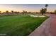 Expansive golf course view with lush green fairway, sand traps, and desert landscaping at 22020 N San Ramon Dr, Sun City West, AZ 85375