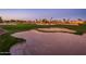 Expansive view of the golf course featuring sand traps and lush greens in a desert landscape at 22020 N San Ramon Dr, Sun City West, AZ 85375