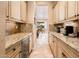 Hallway with granite countertops, plenty of storage, and a wine cooler on the left at 22020 N San Ramon Dr, Sun City West, AZ 85375