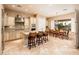 Gourmet kitchen and dining area featuring an island and large windows with outdoor views at 22020 N San Ramon Dr, Sun City West, AZ 85375