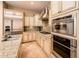 Well-lit kitchen with stainless steel appliances, stone countertops, and ample cabinet space at 22020 N San Ramon Dr, Sun City West, AZ 85375