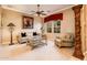 Comfortable living room featuring a decorative column, plush seating, and natural light at 22020 N San Ramon Dr, Sun City West, AZ 85375