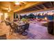 Relax in the spacious covered patio with a golf course view, putting green, and a firepit at 22020 N San Ramon Dr, Sun City West, AZ 85375