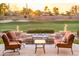 Inviting patio with fire bowls, a water feature, comfortable chairs, and golf course views at 22020 N San Ramon Dr, Sun City West, AZ 85375