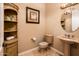 Charming powder room features elegant fixtures, stylish décor, and a space-saving corner shelving unit at 22020 N San Ramon Dr, Sun City West, AZ 85375