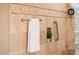 Bathroom shower with decorative tile trim, glass block partition, and towel at 22020 N San Ramon Dr, Sun City West, AZ 85375