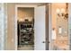 Walk-in closet with organized shoe racks, storage, and view of bathroom at 22020 N San Ramon Dr, Sun City West, AZ 85375