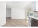 Bright kitchen area featuring wood-look tile flooring and open access to the backyard through a sliding glass door at 2336 W Plata Ave, Mesa, AZ 85202