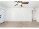 Open-concept living room with wood-look tile flooring, a ceiling fan, and a view into the kitchen at 2336 W Plata Ave, Mesa, AZ 85202