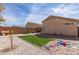 Backyard with a desert landscape, artificial turf, and playground area at 23430 W Pima St, Buckeye, AZ 85326