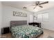 Bright bedroom featuring a ceiling fan and a functional desk area by the window at 23430 W Pima St, Buckeye, AZ 85326