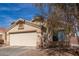 Single-level home with a two-car garage, desert landscaping, and a stucco exterior at 23430 W Pima St, Buckeye, AZ 85326