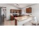 Well-lit kitchen with wood cabinetry, modern appliances, and breakfast bar seating at 23430 W Pima St, Buckeye, AZ 85326