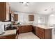 Functional kitchen featuring wood cabinets, a breakfast bar, and ample counter space at 23430 W Pima St, Buckeye, AZ 85326