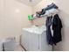 Functional laundry room equipped with a washer, dryer, and storage shelving at 23430 W Pima St, Buckeye, AZ 85326