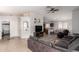 Open-concept living area with tile flooring flowing into the dining and kitchen spaces at 23430 W Pima St, Buckeye, AZ 85326