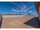 Backyard view showing block fence, dirt lot and blue skies at 24066 S 218Th Pl, Queen Creek, AZ 85142