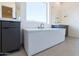 Bright bathroom featuring a modern soaking tub, dual vanities, and a large window at 24066 S 218Th Pl, Queen Creek, AZ 85142