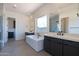 Modern bathroom showcasing soaking tub, dual vanities, and shower with glass enclosure at 24066 S 218Th Pl, Queen Creek, AZ 85142