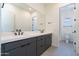 Modern bathroom featuring a double sink vanity, white countertop, and sleek black fixtures, offering a clean aesthetic at 24066 S 218Th Pl, Queen Creek, AZ 85142