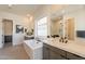 Bright bathroom featuring a modern tub, sleek vanity with black fixtures, and a window offering natural light at 24066 S 218Th Pl, Queen Creek, AZ 85142