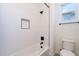 Bright bathroom featuring a white tub, shower, and toilet, complemented by a window for ample natural light at 24066 S 218Th Pl, Queen Creek, AZ 85142