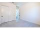 Neutral bedroom with gray carpet, white walls, closet, and an open door to another room at 24066 S 218Th Pl, Queen Creek, AZ 85142