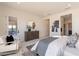 Bedroom with a decorative dresser, a mirror, and natural lighting at 24066 S 218Th Pl, Queen Creek, AZ 85142