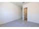 This is a bedroom featuring neutral walls and carpet, with an open door to the bathroom at 24066 S 218Th Pl, Queen Creek, AZ 85142