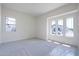 Bright, neutral bedroom with gray carpet, white walls, and a window offering natural light at 24066 S 218Th Pl, Queen Creek, AZ 85142