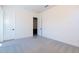 Neutral bedroom featuring gray carpet, white walls, and an open door to another room at 24066 S 218Th Pl, Queen Creek, AZ 85142