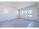 Bright bedroom with neutral carpet, multiple windows, and recessed lighting at 24066 S 218Th Pl, Queen Creek, AZ 85142