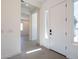 Inviting entryway with modern white door, side window, and neutral colors creating a bright, welcoming space at 24066 S 218Th Pl, Queen Creek, AZ 85142