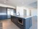 Modern kitchen island with stainless steel appliances, dark cabinets, and white countertop enhancing functionality at 24066 S 218Th Pl, Queen Creek, AZ 85142