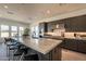 A modern kitchen island with counter seating, stainless appliances, and gray cabinetry at 24066 S 218Th Pl, Queen Creek, AZ 85142