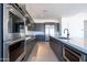 Modern kitchen with stainless steel appliances and sleek gray cabinetry at 24066 S 218Th Pl, Queen Creek, AZ 85142