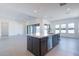 Open-concept kitchen showcasing an island with seating, dark cabinetry, and modern stainless steel appliances at 24066 S 218Th Pl, Queen Creek, AZ 85142