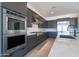 Sleek kitchen featuring stainless steel appliances, dark cabinets, and a white countertop island for efficient cooking at 24066 S 218Th Pl, Queen Creek, AZ 85142