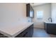 Well-lit laundry room with modern cabinets, countertop, sink and window at 24066 S 218Th Pl, Queen Creek, AZ 85142