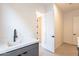 Bright laundry room featuring modern cabinets, countertop space, and tile flooring, blending style and utility at 24066 S 218Th Pl, Queen Creek, AZ 85142