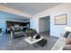 Open concept living room with modern furniture, natural light, and a view of the kitchen at 24066 S 218Th Pl, Queen Creek, AZ 85142