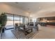 Bright living room with a sliding glass door, modern furniture, and a view of the open floor plan at 24066 S 218Th Pl, Queen Creek, AZ 85142