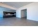 Open floor plan with living room, dining area, and modern dark cabinets creating a unified living space at 24066 S 218Th Pl, Queen Creek, AZ 85142