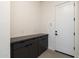 Functional mudroom with dark cabinetry, neutral walls, and a white door at 24066 S 218Th Pl, Queen Creek, AZ 85142