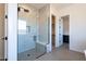 Contemporary shower with glass door, marble tile, and a built-in bench seat at 24066 S 218Th Pl, Queen Creek, AZ 85142